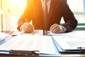 Businessman analyzing financial statements in the office